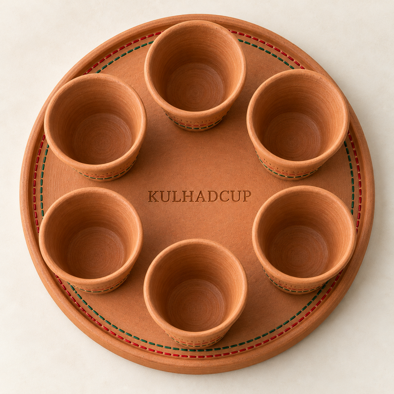 Top view of round terracotta tray with six mustard indigo kulhads